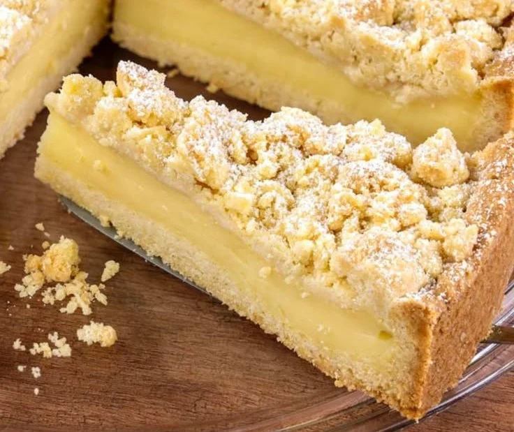 Streuselkuchen mit Pudding auf einem Teller serviert